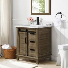 a bathroom with a sink, mirror and towel rack on the wall next to it