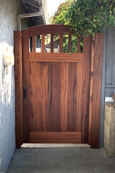 a wooden door is open on the side of a house