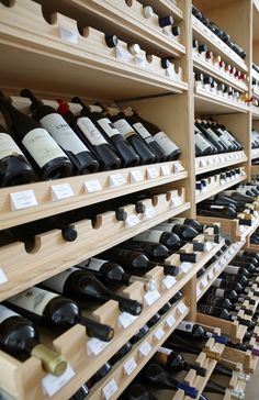 many bottles of wine are lined up on shelves