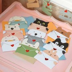 a pink tray filled with lots of cut out animals on top of eachother