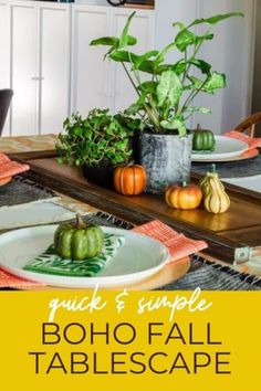 the table is set with pumpkins and green plants for an easy fall centerpiece