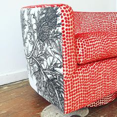 a red and white chair sitting on top of a hard wood floor