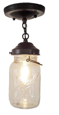 a mason jar hanging from the ceiling with a light on it's side and an old - fashioned pull chain