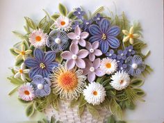 a basket filled with lots of flowers on top of a table