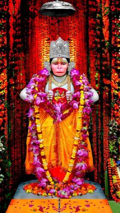 an idol is displayed in the middle of a stage with flowers and petals around it