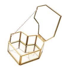 an open glass box with a chain hanging from the bottom, on a white background