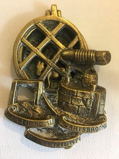 an antique brass brooch depicting a steam engine