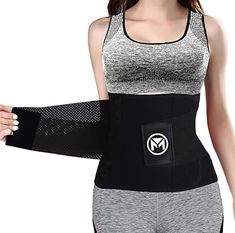 a woman wearing a black and white sports bra with an arm brace in front of her