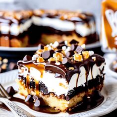 a piece of cake with chocolate and marshmallows on it sitting on a plate