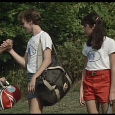 three young people are talking to each other