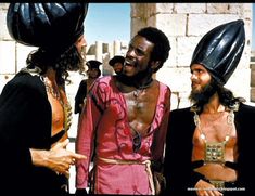 three men in costumes talking to each other