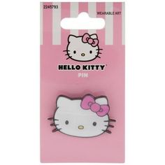 a pink hello kitty pin sitting on top of a card board in a packaging bag