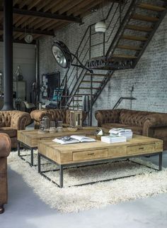 a living room filled with furniture and a spiral staircase