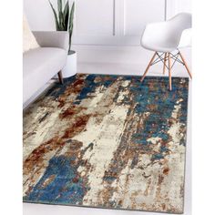 an area rug with blue, brown and white colors on the floor in a living room