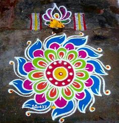 a colorful flower design painted on the ground