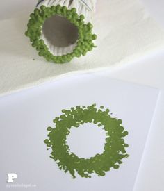 some type of green object sitting on top of white paper