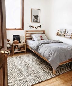 a bedroom with a bed, nightstands and pictures hanging on the wall above it