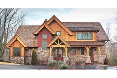 a large house with stone and wood accents