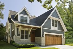 a large house with two garages on the front and one above it's door