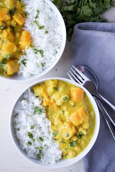 two white bowls filled with rice and curry