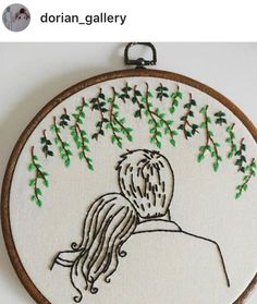 an embroidery project with a woman's head and green leaves on the back of it