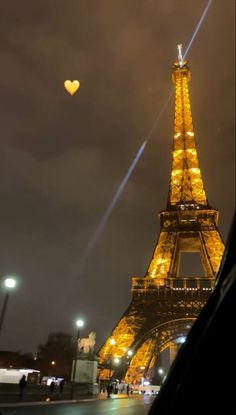 the eiffel tower is lit up at night