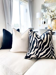 a white couch with black and white pillows