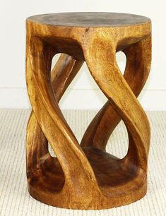 a wooden stool with an unusual design on it