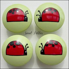 four red ladybug buttons with black dots on them