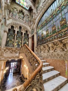 an ornate stair case with stained glass windows