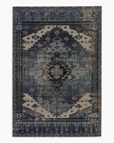 a blue rug with an intricate design on the front and back side, in various colors