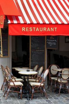 the outside of a restaurant with tables and chairs under an awning that reads restaurant