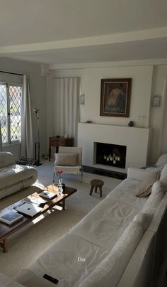 a living room filled with furniture and a fire place