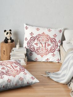 a bed room with two pillows and a stuffed panda bear on the floor next to it