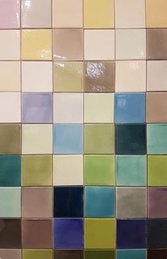 multicolored tiles are arranged on the wall