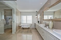 a large bathroom with two sinks and a bathtub