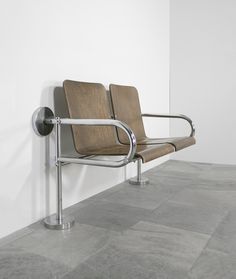 an empty waiting room with two chairs on the wall