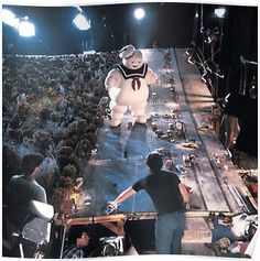 an inflatable ghost walking across a stage surrounded by people