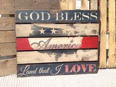 a wooden sign that says god bless america land that i love