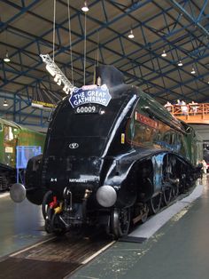 an old fashioned train is on display in a museum