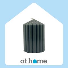 the logo for at home is shown in front of an image of a black candle