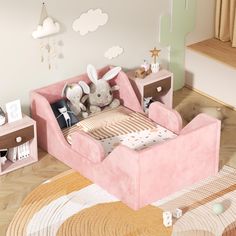 a child's room with a pink couch and stuffed animals on the side table