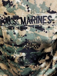 the back of a man's uniform with words on it that read, us marines