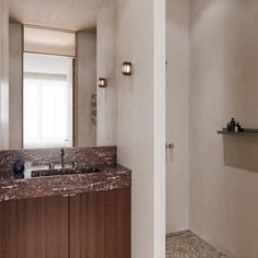 a bathroom with marble counter tops and wooden cabinets