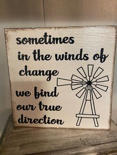 a wooden sign that says sometimes in the winds of change we find our true direction