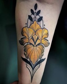 a yellow flower tattoo on the leg