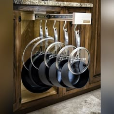 pots and pans are hanging on the rack in this kitchen cabinet for $ 15 75