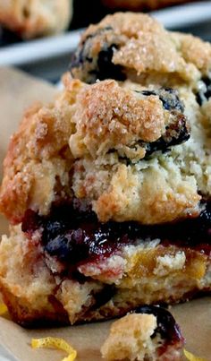 a stack of blueberry crumbs sitting on top of a white plate next to orange slices