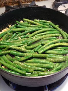 green beans cooking in a skillet on the stove