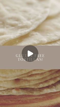 a pile of tortilla sitting on top of a wooden cutting board